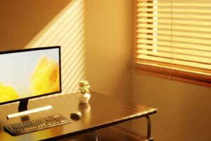 computer on a table near window