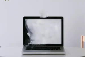 image of a smoking laptop on a table