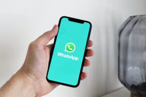WhatsApp logo on phone screen